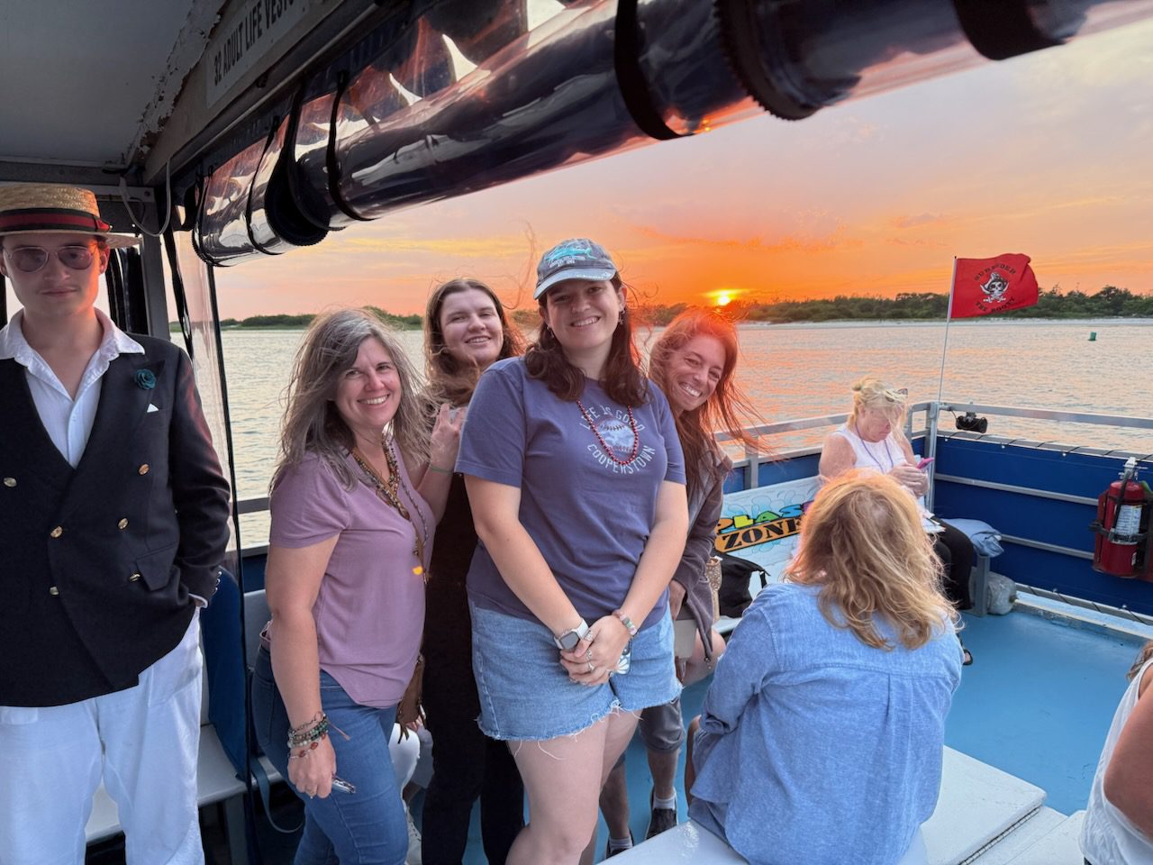 People on boat with sunset backdrop