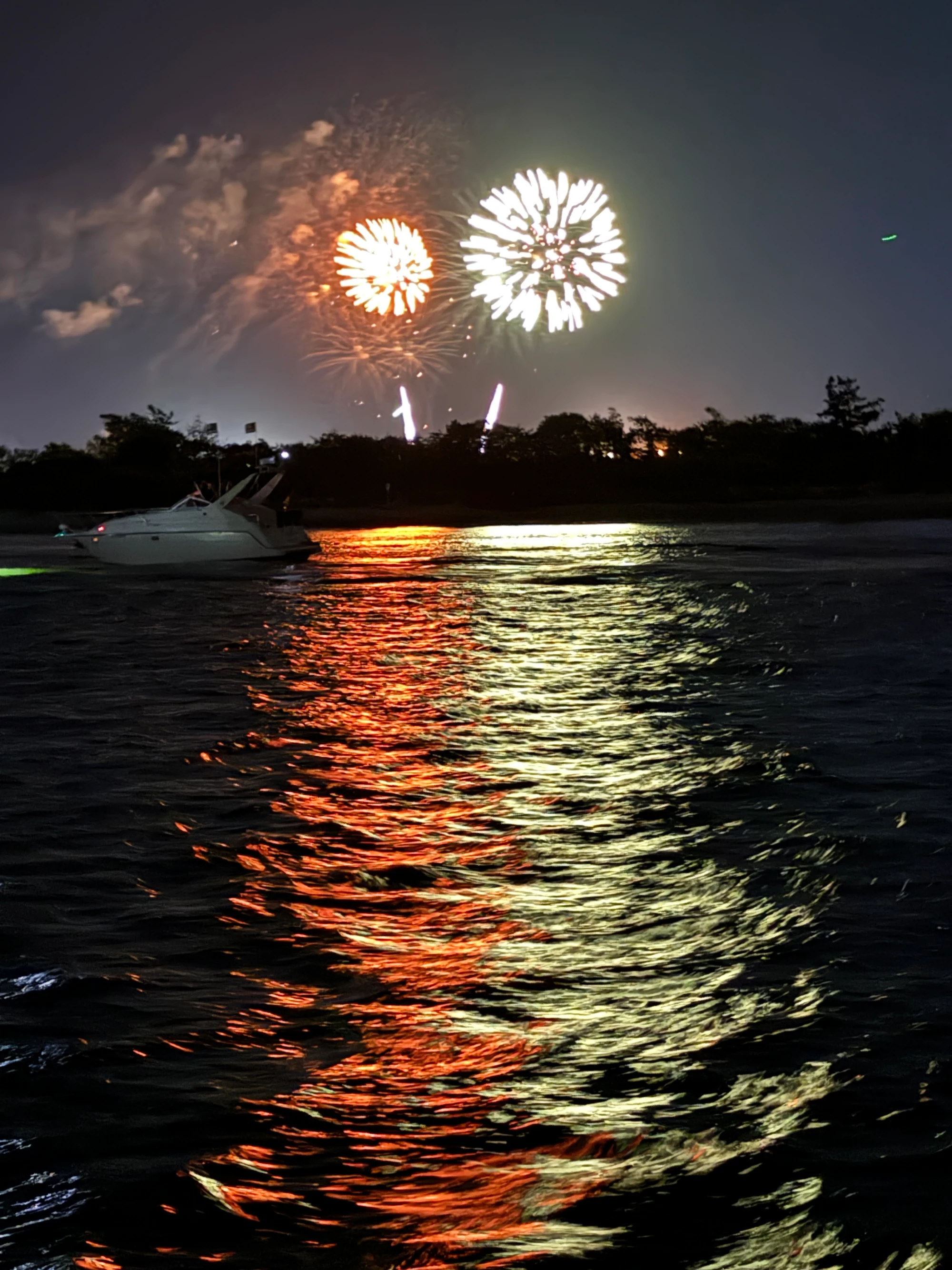 Bright fireworks reflecting on lake