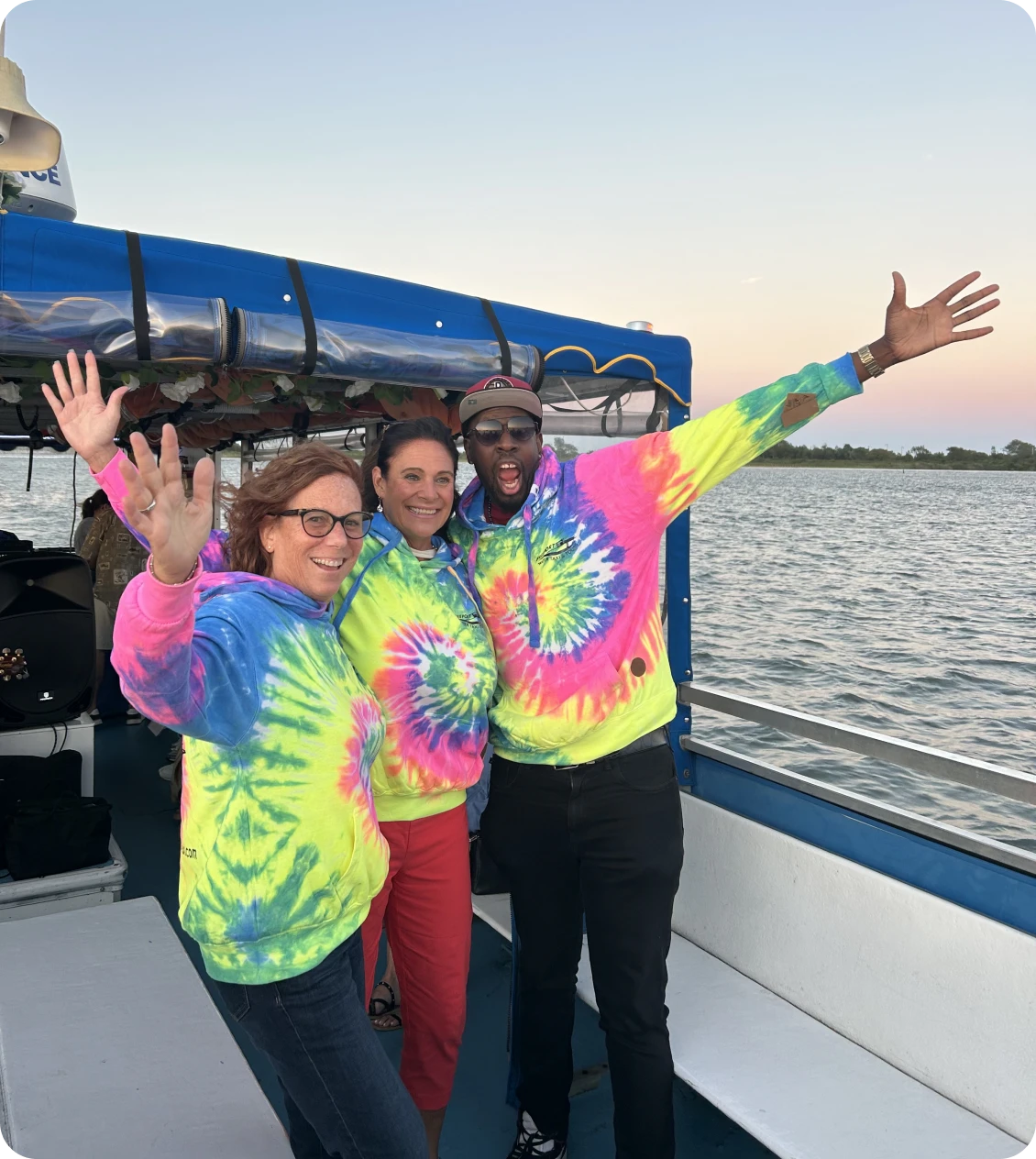 Friends enjoying a boat ride in tie-dye