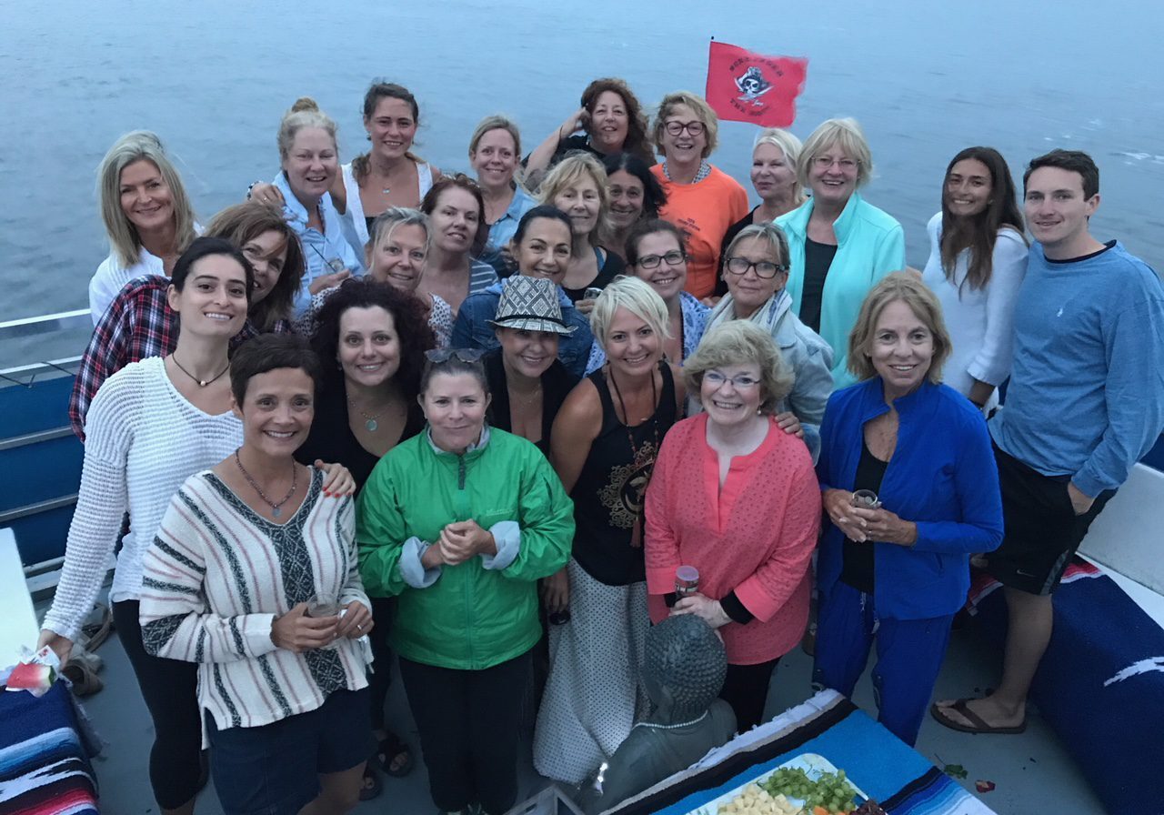 Smiling group with a pirate flag